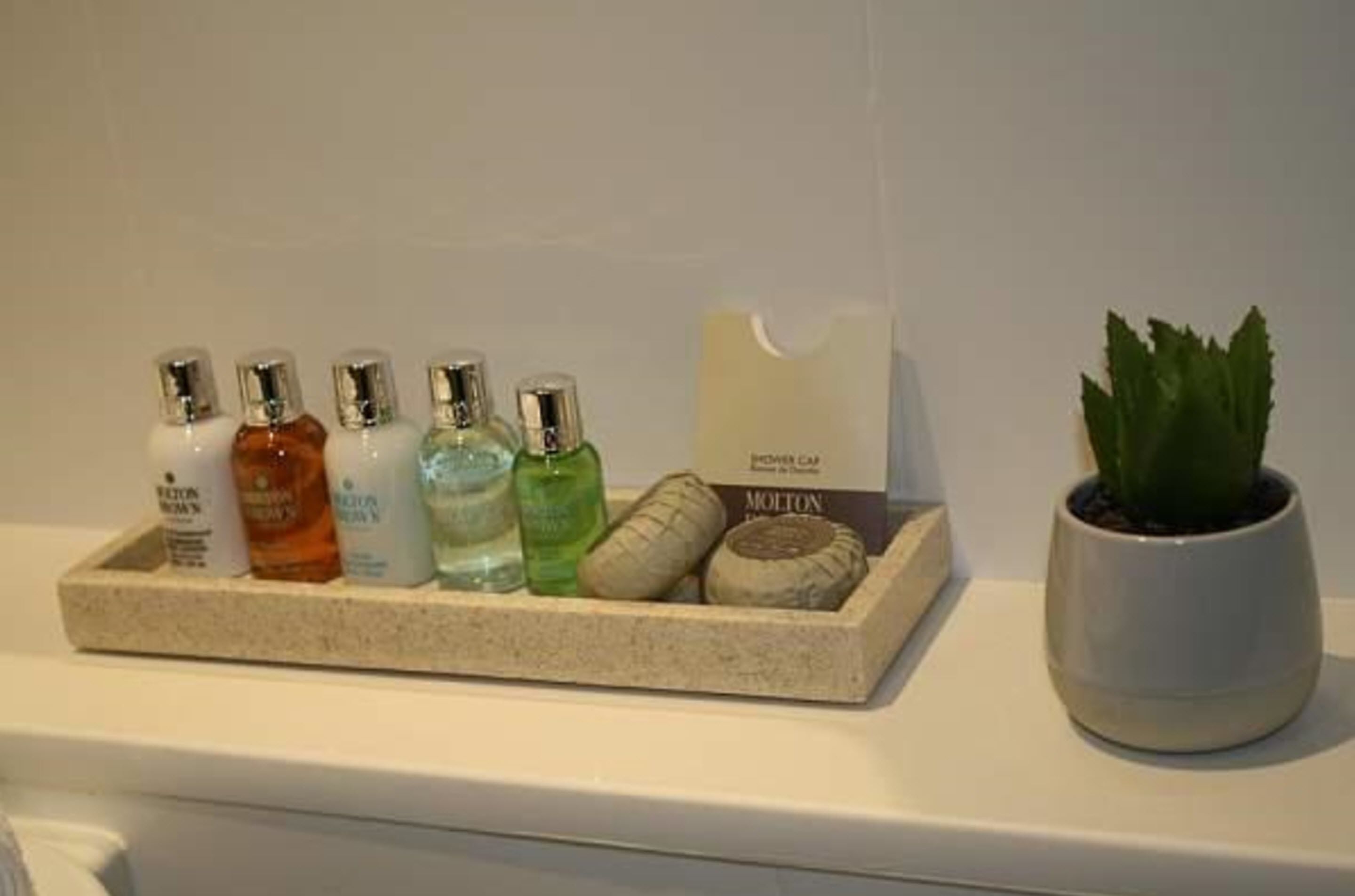 designer toiletries, hair dryer, towels