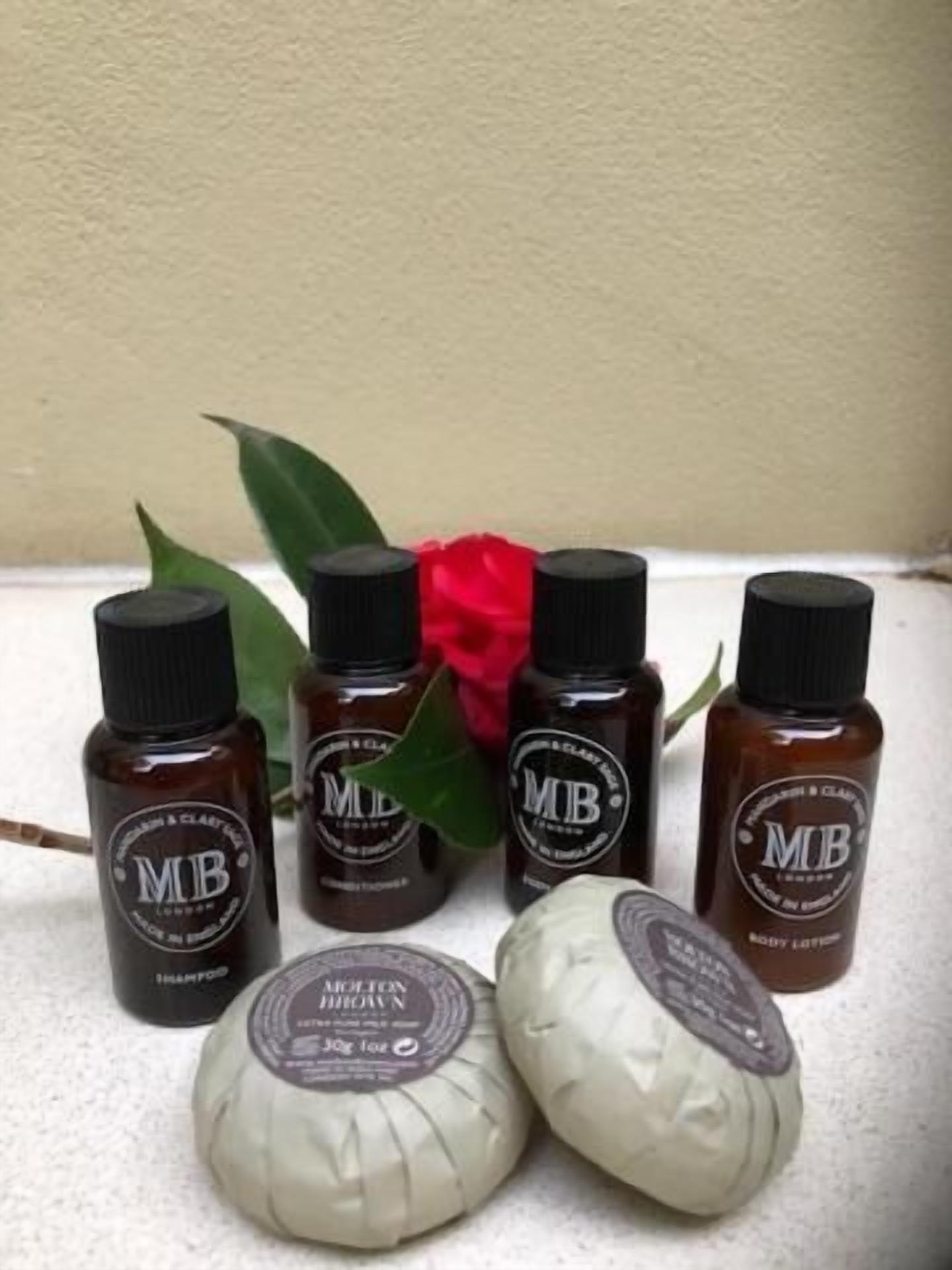 designer toiletries, hair dryer, towels