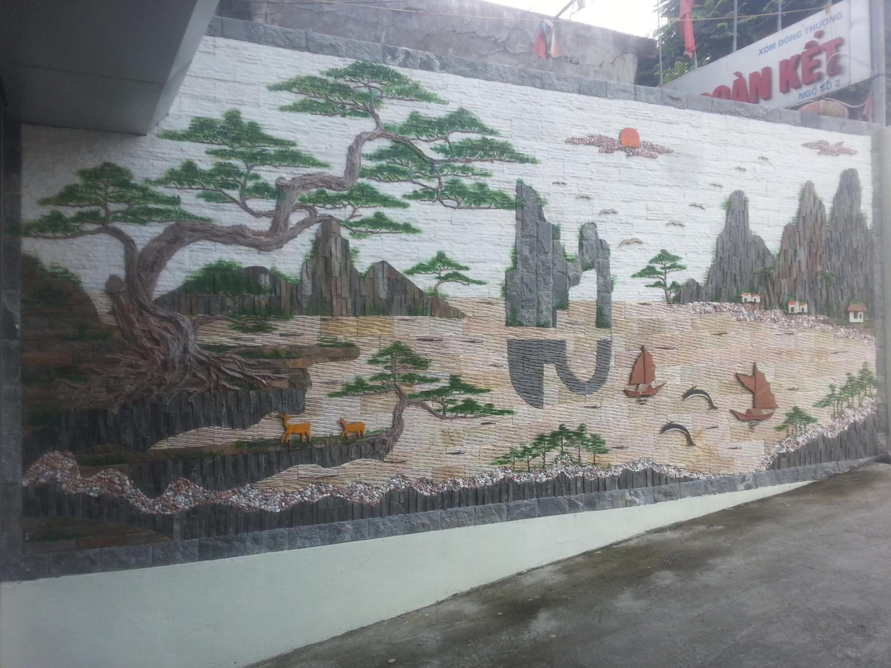 A mural with a mountainous landscape and a river.