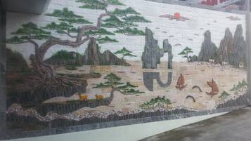 A mural with a mountainous landscape and a river.