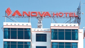 A modern hotel with a prominent sign reading "NOVAVA HOTEL". - AVS NOIBAI HOTEL  (Hanoi)