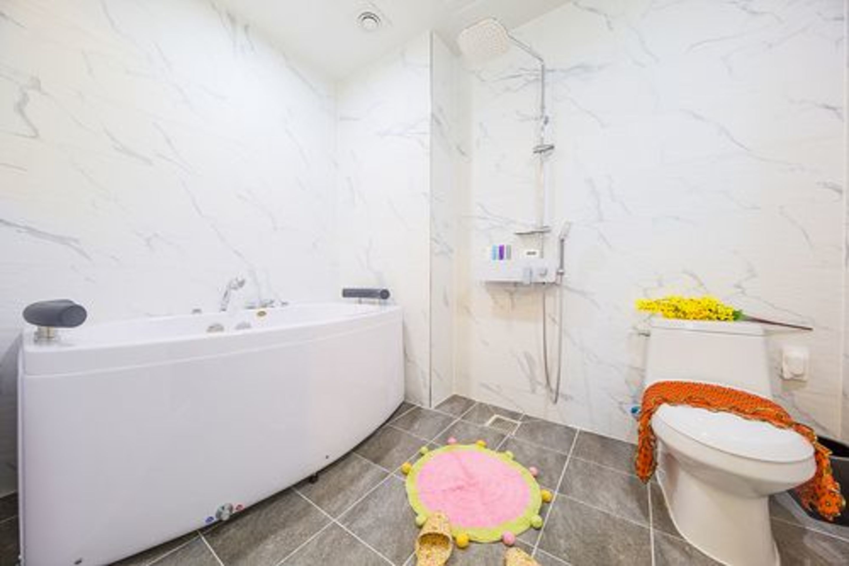 A bathroom with a bathtub, toilet, and shower.