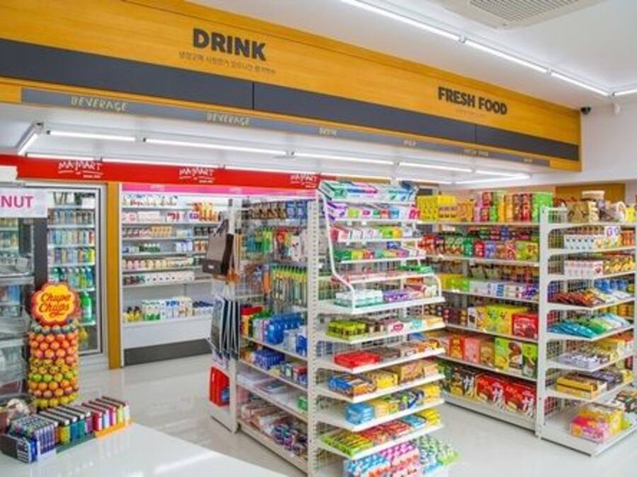 A supermarket with sections labeled 'DRINK' and 'FRESH FOOD'.