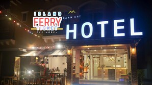 The exterior of Island Ferry Ticket Hotel with a prominent sign and a well-lit entrance. - Baan URT Suratthani Airport Hotel (Phunphin)