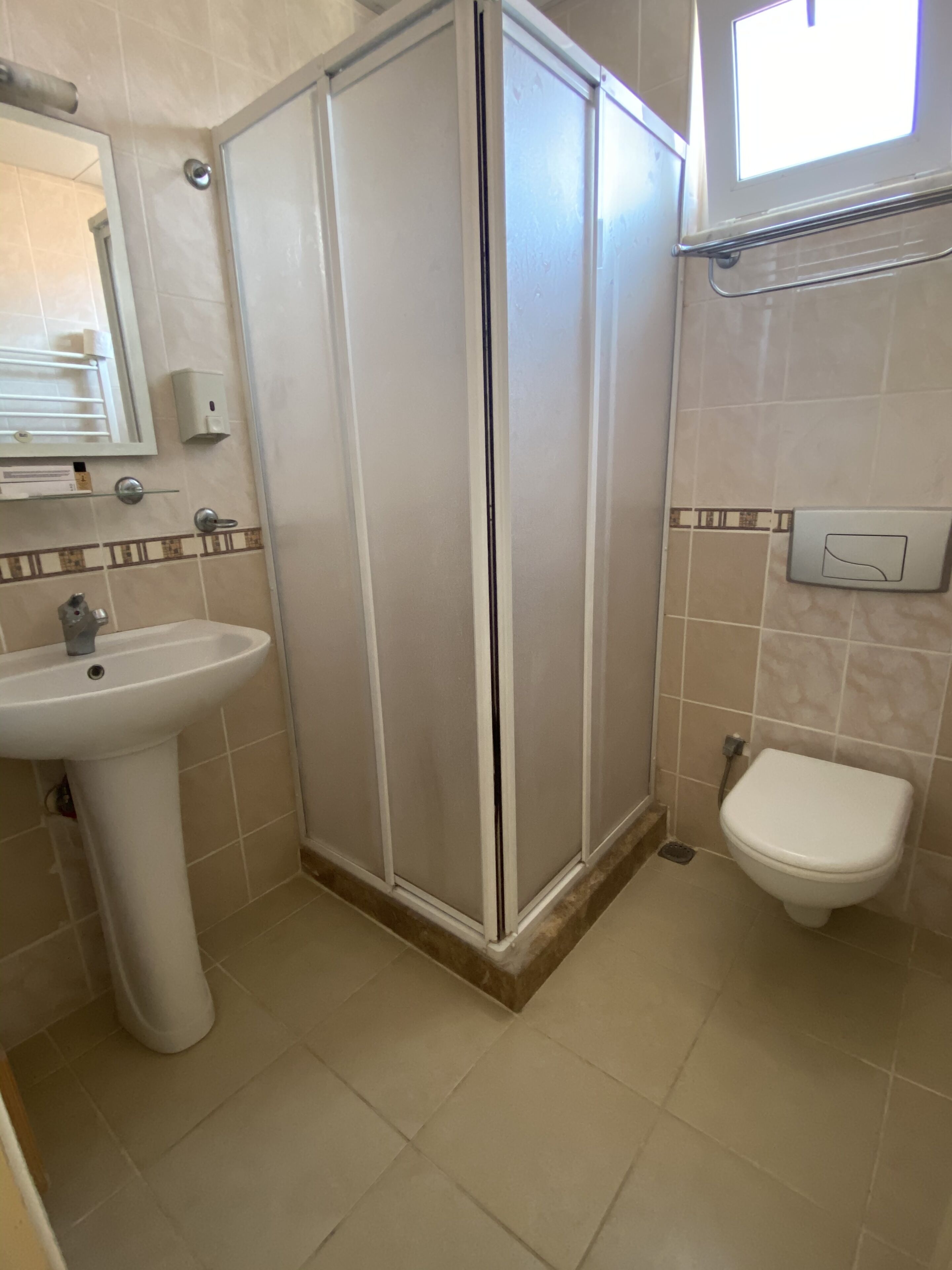 shower, hair dryer, slippers, towels