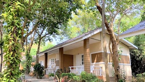 A two-story building with a porch, surrounded by greenery and trees. - Malibu Samed resort (Rayong)