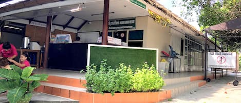 A reception area with a sign indicating 'No Entrance' and a 'Left Luggage' sign.