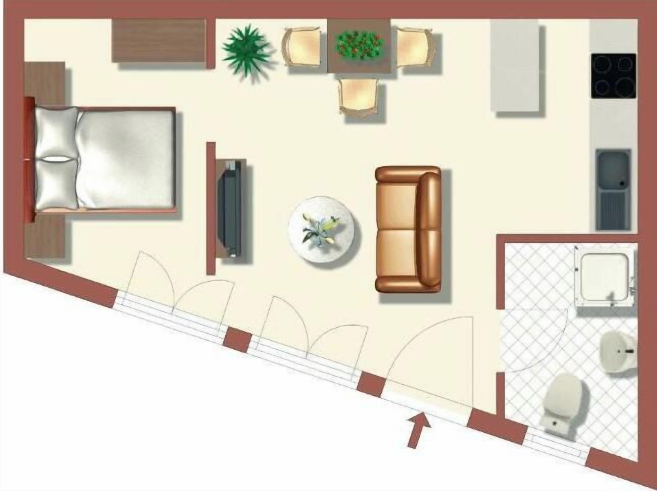 A hotel room with a bed, a sofa, a TV, a dining table with chairs, a kitchen area, and a bathroom.