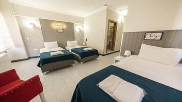 Classic Quadruple Room | Minibar, in-room safe, individually decorated, individually furnished