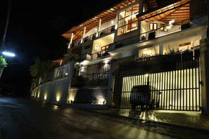 Guests can enjoy a balcony with potted plants from this upper-floor residence.
