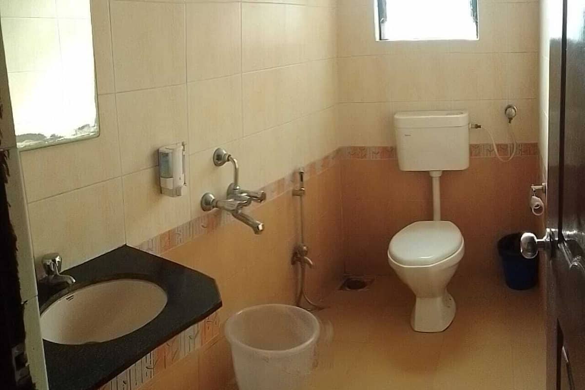 A bathroom with a sink, toilet, and shower.