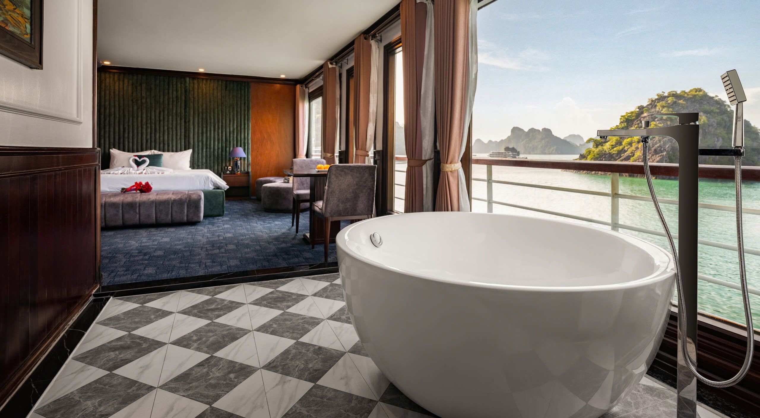 A hotel room with a large bathtub, a bed, a dining area, and a view of the water.