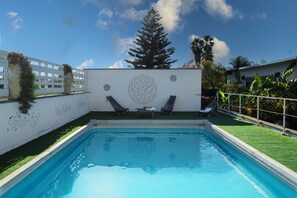 Seasonal outdoor pool, pool loungers