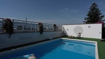 Seasonal outdoor pool, pool loungers