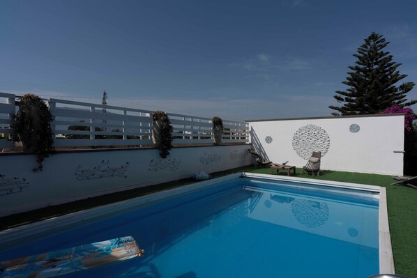 Seasonal outdoor pool, pool loungers