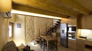 A modern kitchen with a wooden ceiling, a built-in stove, and a refrigerator. - Evans House II (Chania)