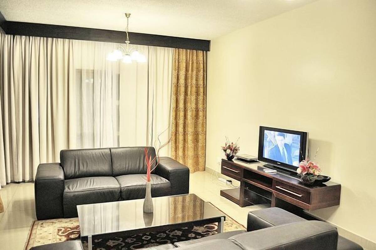 Luxury Suite, 1 Bedroom | Living room | Flat-screen TV