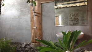 A bathroom with a shower, sink, and a mirror. - Banter Resort (Buriram)