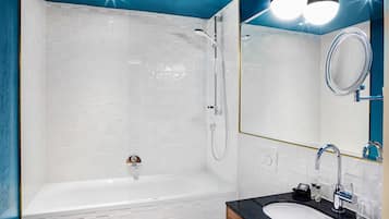 Un baño moderno con bañera, lavabo y espejo.