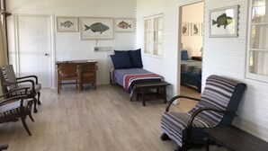 A room with a bed, two chairs, a desk, and a window. - Gulls Way (The Crags)