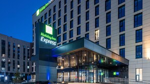 A Holiday Inn Express hotel with a modern facade, large windows, and a prominent entrance. - Holiday Inn Express Astana - Turan (Astana)