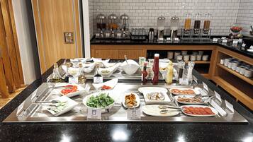 A buffet with various food items and condiments.
