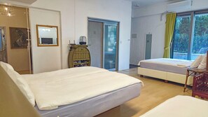 A hotel room with two beds, a wooden cabinet, a mirror, and a window with curtains. - OROJEJU (Seogwipo)