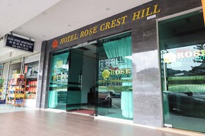 The exterior of Hotel Rose Crest Hill with a clear entrance, a signboard above the entrance, and a visible car parked outside. - Hotel Rose Crest Hill, Cameron Highlands (Tanah Rata)