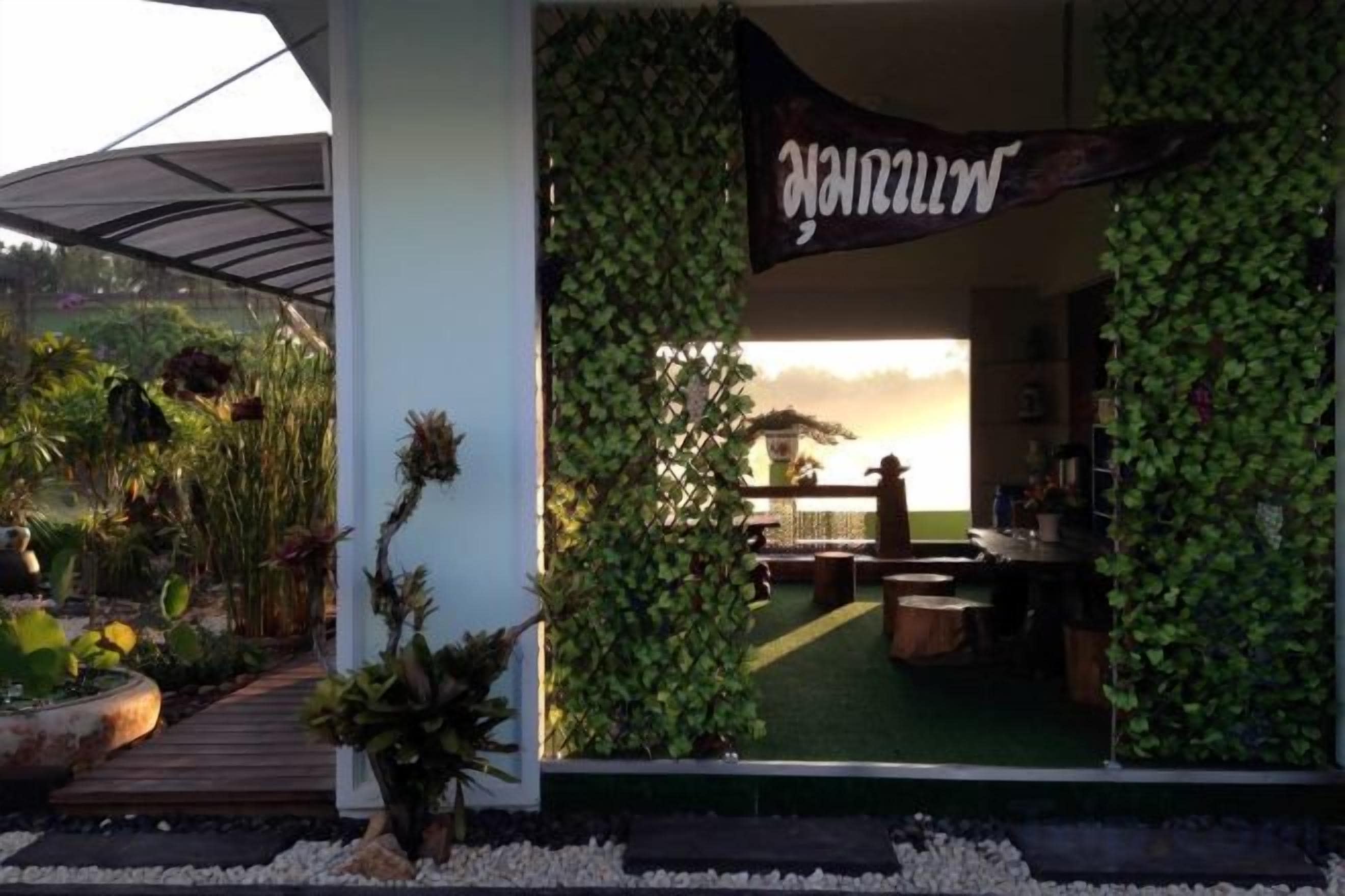 A hotel entrance with a green wall and a banner.