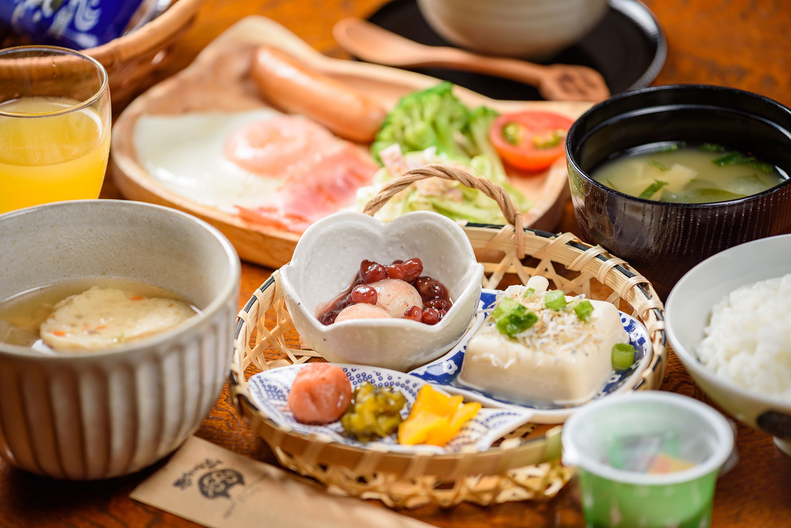 A variety of Japanese dishes including sushi, sashimi, and a bowl of soup.