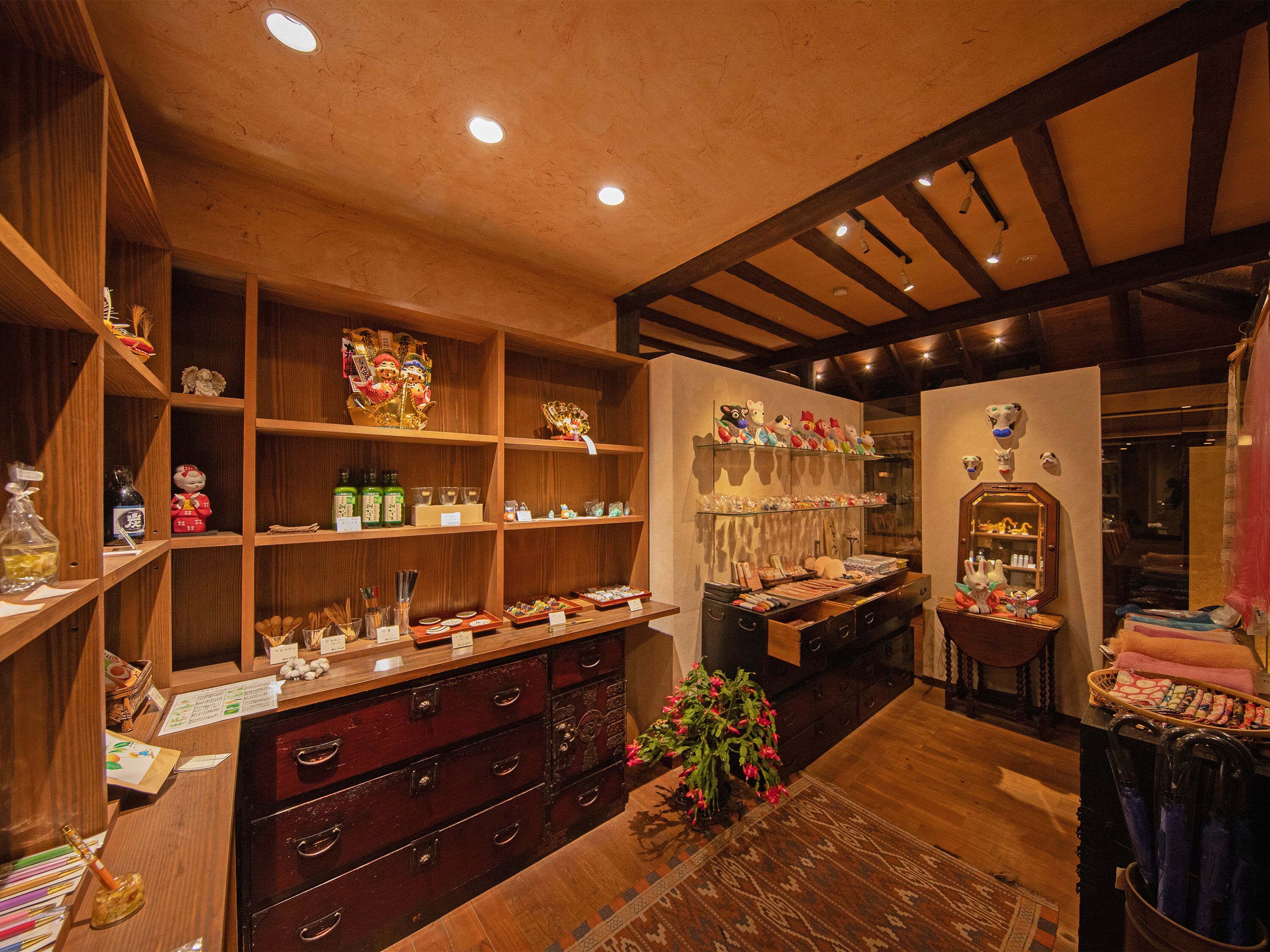 A traditional Japanese room with wooden shelves, a wooden dresser, and a mirror.