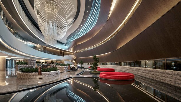A modern interior with a central water feature, seating areas, and a unique ceiling design. - PRIMUS Hotel Shanghai Hongqiao (Shanghai)
