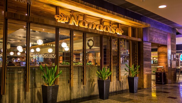 A restaurant with a wooden facade and large windows. - Eastern Suites at Times Square KL (Kuala Lumpur)