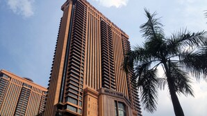 A tall, modern building with a prominent 'BERJAYA' sign, featuring a vertical design with numerous windows and a central entrance. - Eastern Suites at Times Square KL (Kuala Lumpur)