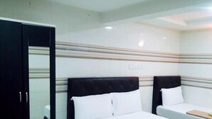 A hotel room with two beds, a wardrobe, and a wall-mounted control panel. - Sungai Besi Hotel (Seri Kembangan)