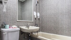 Un baño con inodoro, lavamanos y bañera.