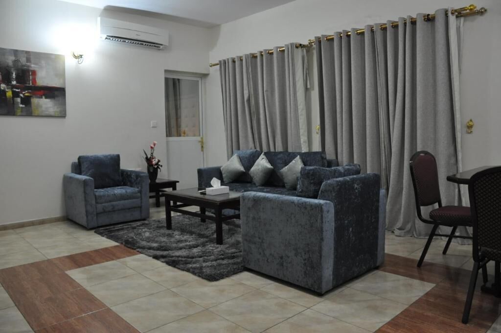 A living room with a sofa, armchair, and coffee table.