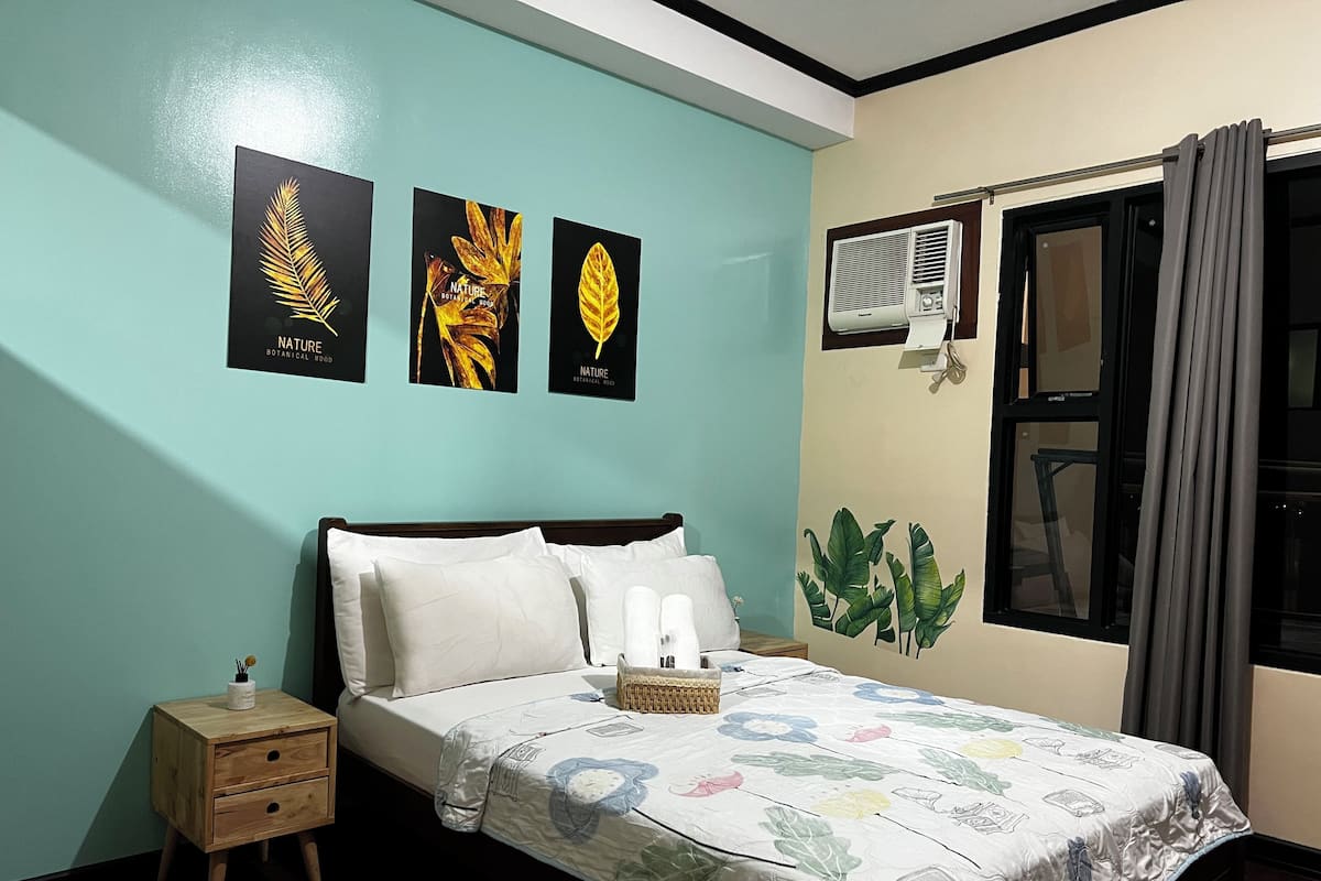 Hypo-allergenic bedding, desk, laptop workspace, blackout drapes