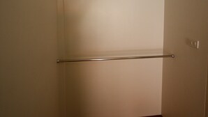 A narrow hallway with a wooden floor and a metal handrail on the left. - Sweethome Resort (Surin)