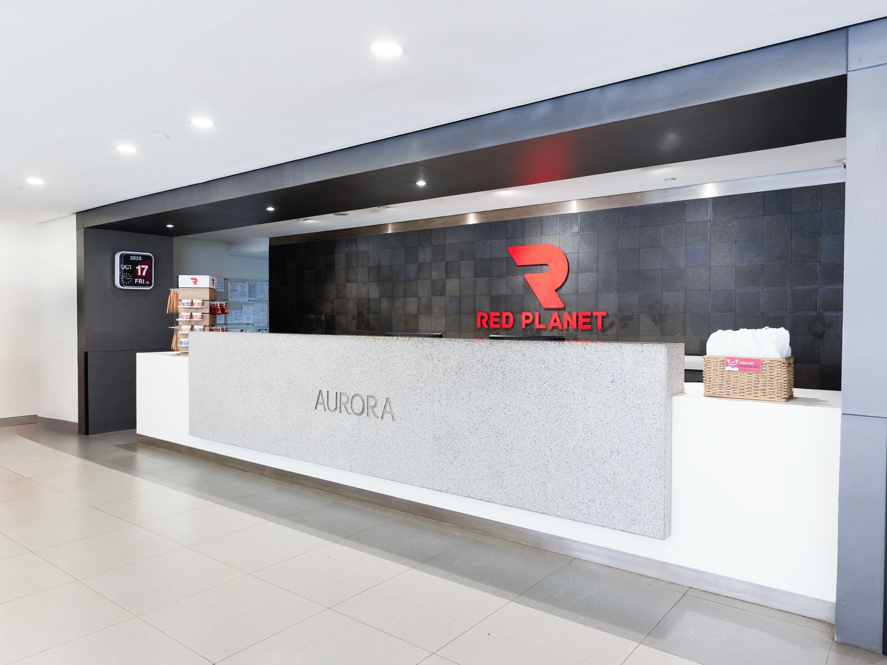 A reception desk with a 'RED PLANET' logo and 'AURORA' signage.