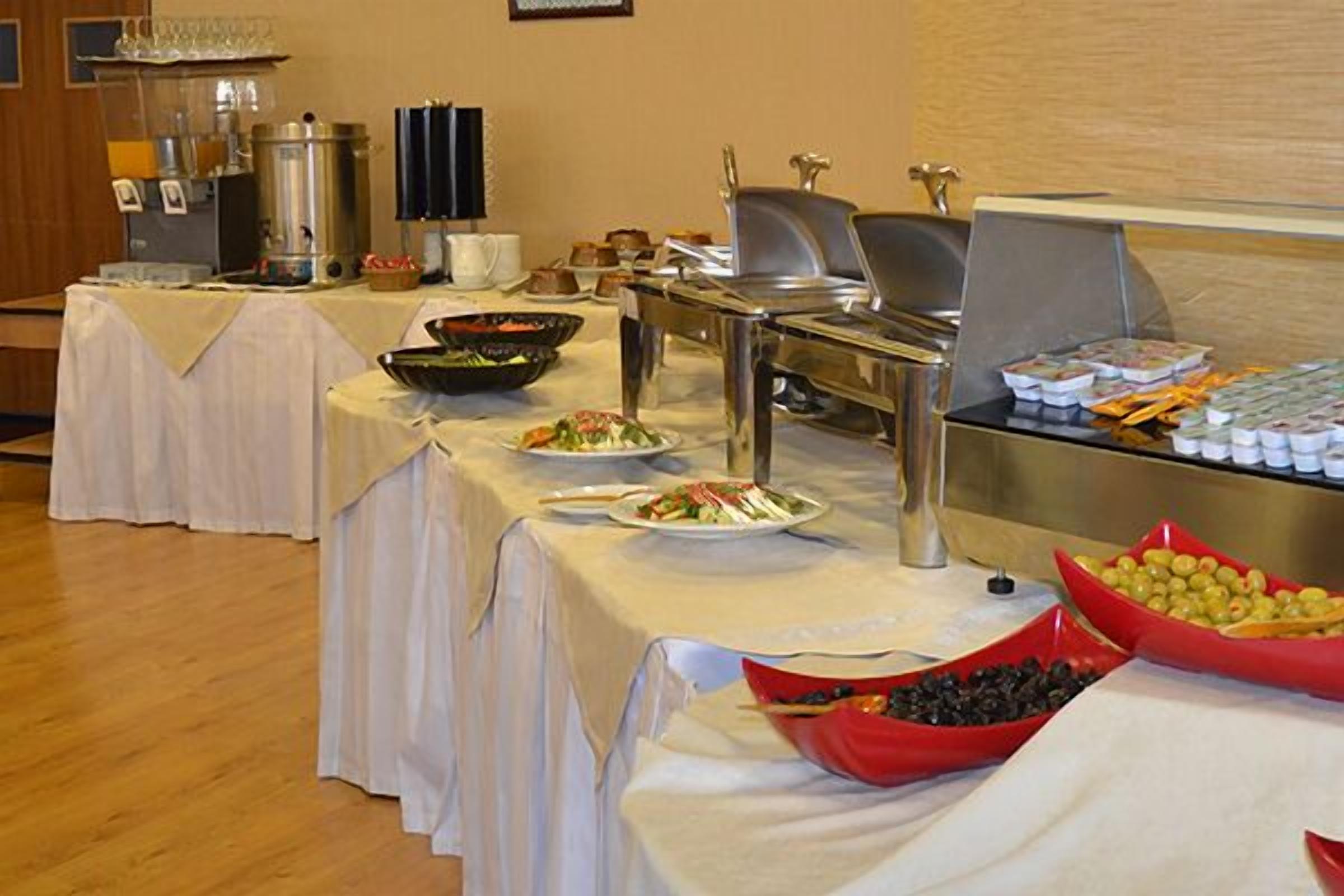 A buffet setup with various food items and beverages.