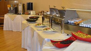 A buffet setup with various food items and beverages.