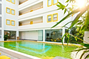 Outdoor pool, open 8 AM to 8 PM, pool umbrellas
