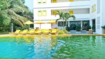 Outdoor pool, open 8 AM to 8 PM, pool umbrellas