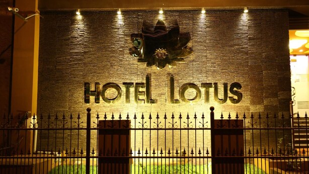 A hotel entrance with a sign reading "HOTEL LOTUS" and a decorative emblem above it. - Hotel Lotus (Madurai)