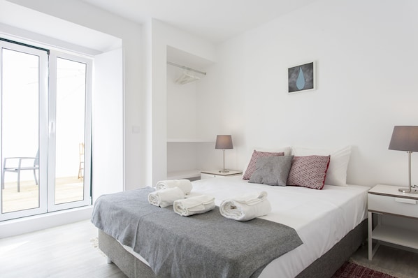 Relax in a serene space with a large bed, two bedside tables, and a beautiful view.