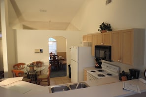 Enjoy cooking in this kitchen with a central island featuring a sink, microwave, and stove.