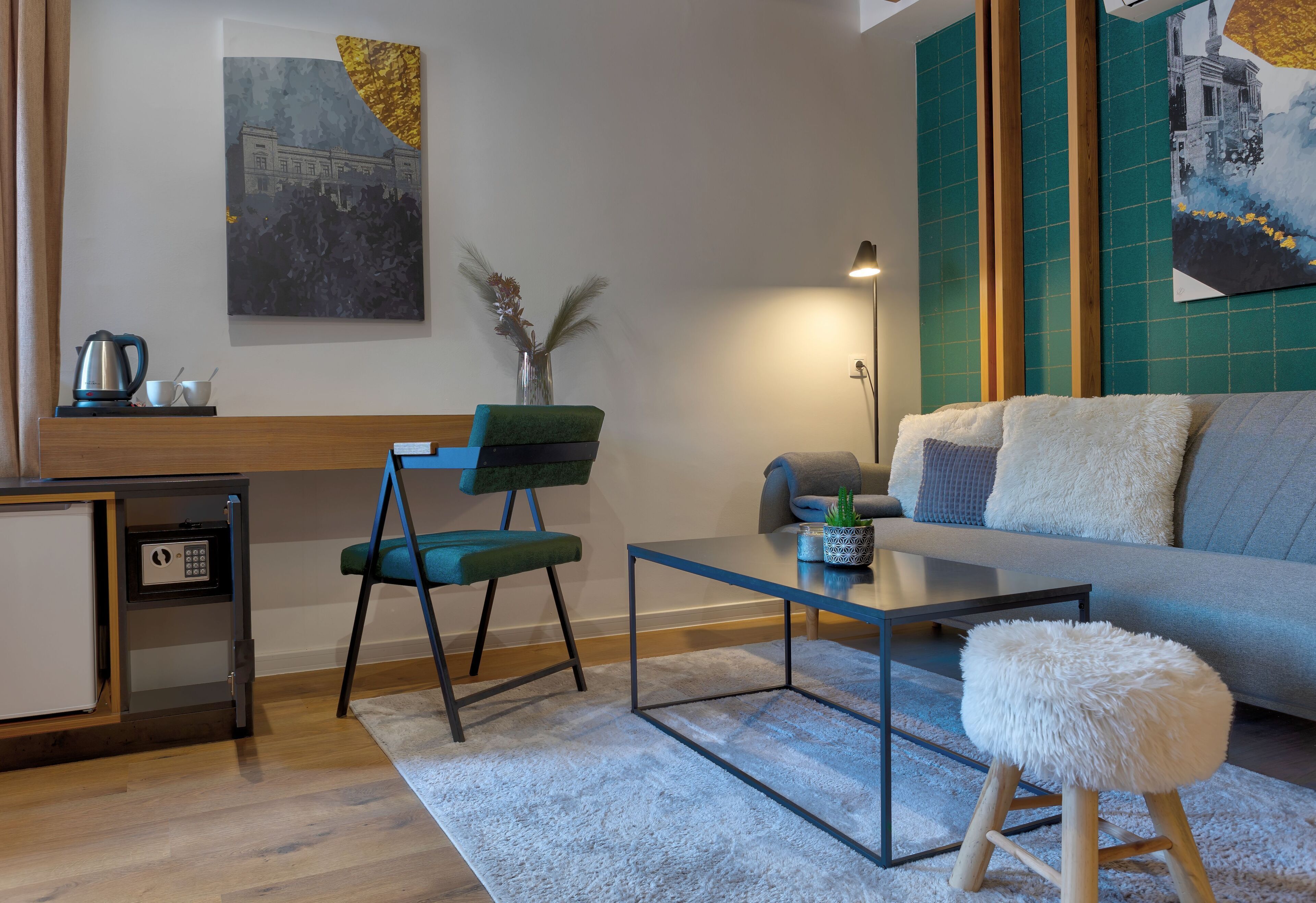 A modern living room with a sofa, a coffee table, a chair, a small side table, and a decorative plant.