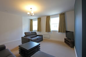 City Duplex, 2 Bedrooms | Living room | 50-inch flat-screen TV with cable channels, TV
