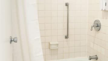 A bathroom with a bathtub, a shower, a toilet, and a sink.